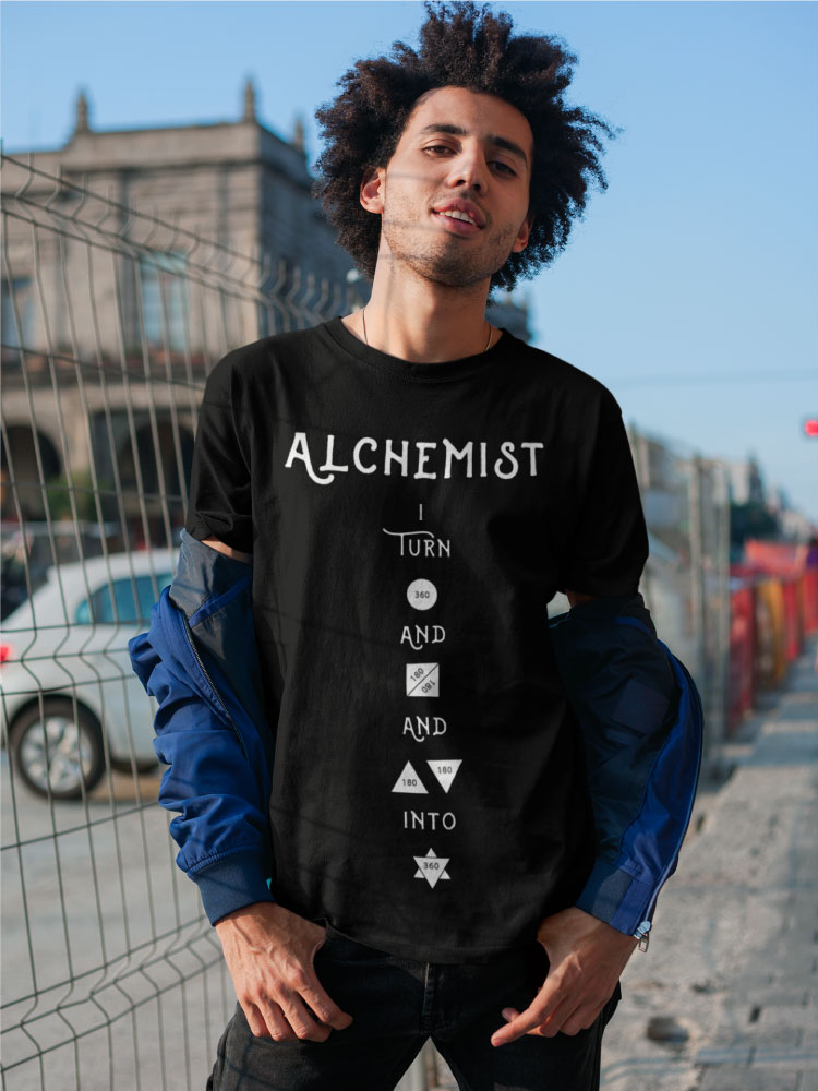 AwakenAware.com-Awake-&-Aware-mockup-of-a-man-with-a-coy-smile-wearing-an-Alchemist-t-shirt-18077